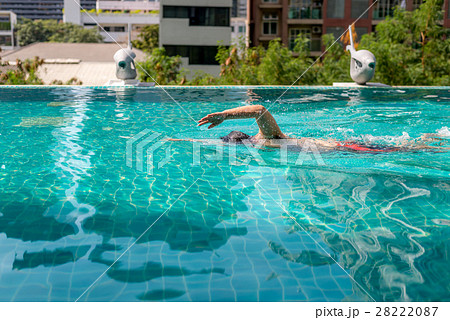 Man swimming forward crawl style in swimming pool Man swimming forward crawl style in swimming pool 28222087