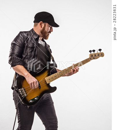 Bassist plays bass guitar. Bassist plays bass guitar. 28223631