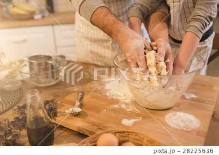 A father and his son cooking 28225636