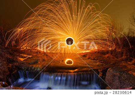 Burning sparks in the night winter landscape 28230614