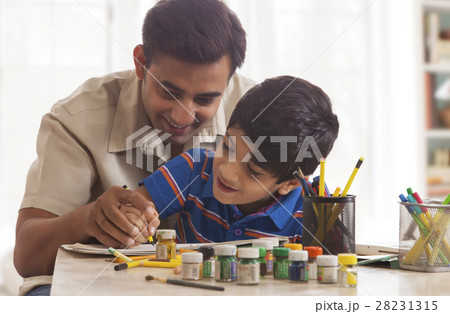 Father and son painting crafts at home 28231315