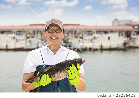 happy fisherman showing  fish before fishing ship 28256425