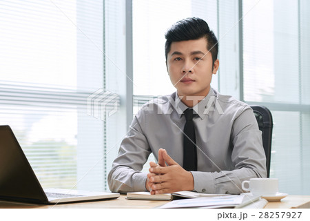 Handsome businessman looking at camera Handsome businessman looking at camera 28257927