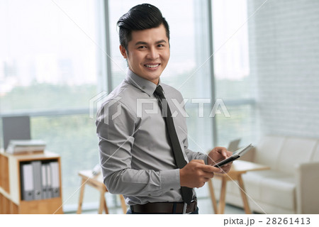 Smiling businessman with digital tablet Smiling businessman with digital tablet 28261413