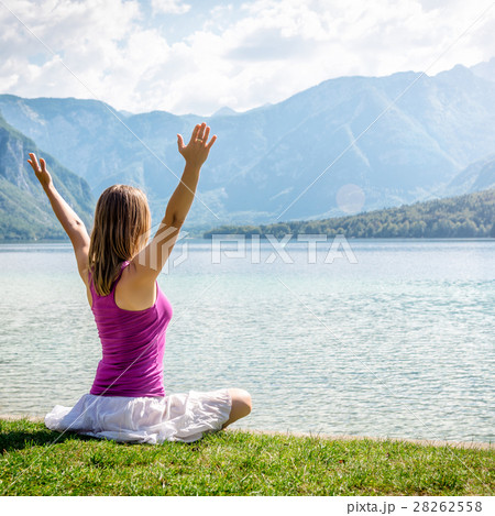 Woman meditating at the lake Woman meditating at the lake 28262558