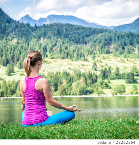 Woman meditating at the lake 28262564