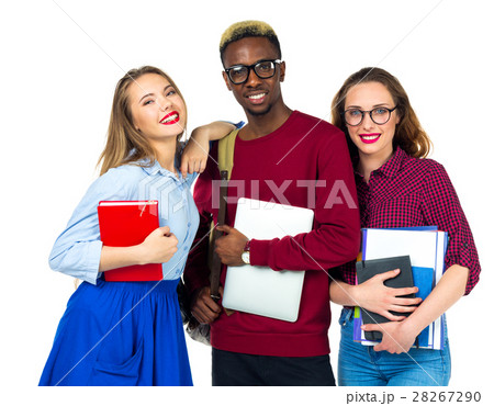 Three students standing and smiling with books Three students standing and smiling with books 28267290