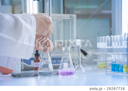 Scientist dropping sample in flask 28267738