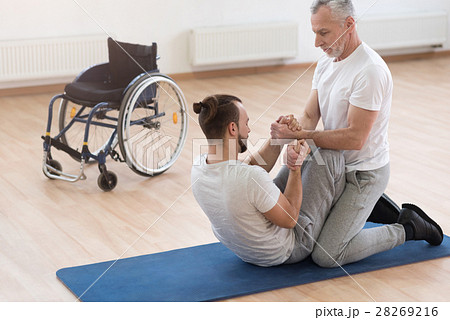 Skilled orthopedist assisting the disabled in the 28269216