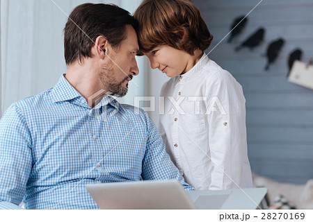 Nice pleasant father and son looking at each other 28270169