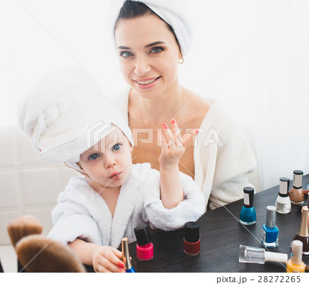 Beautiful woman and her daughter making manicure 28272265