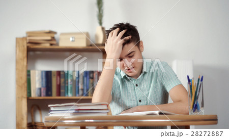 Upset schoolboy doing homework 28272887