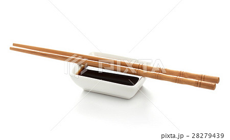 Soy sauce and chopsticks isolated on white Soy sauce and chopsticks isolated on white 28279439