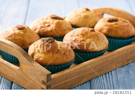 Sweet muffins with almond on blue wooden table. 28282351