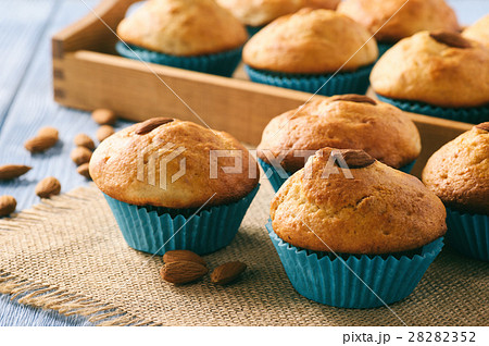 Sweet muffins with almond on blue wooden table. 28282352