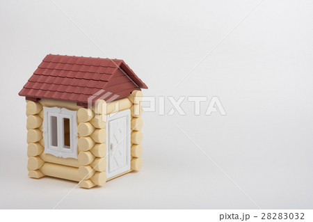 Toy house on a white background, near a place under an inscription 28283032