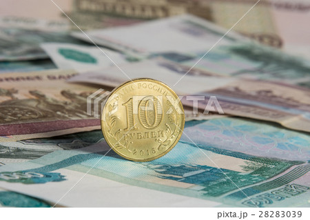 On the Russian paper banknotes standing on the edge of Russian ten-coin On the Russian paper banknotes standing on the edge of Russian ten-coin 28283039