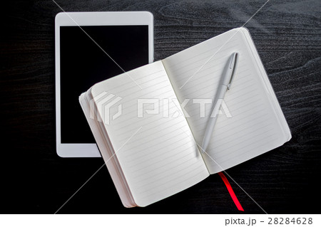 Notebook with red bookmark on a table Notebook with red bookmark on a table 28284628