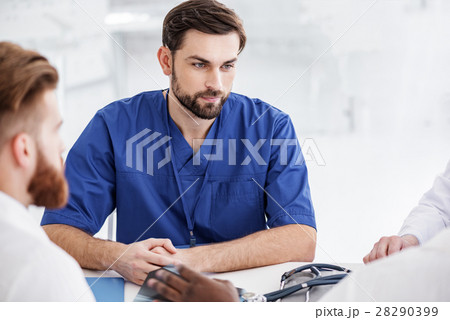 Outgoing doctor situating with colleagues during 28290399