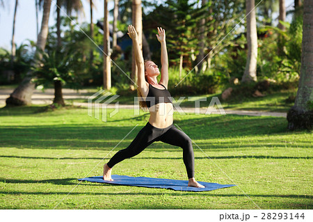 Attractive woman practices yoga in nature.. 28293144