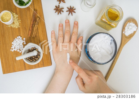 Woman is applying home made cream on hand. 28303186