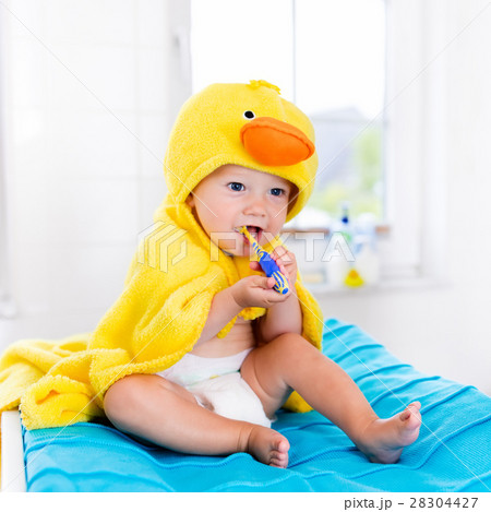 Baby in bath towel with tooth brush Baby in bath towel with tooth brush 28304427