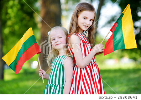 Two pretty little sisters holding tricolor Lithuanian flags Two pretty little sisters holding tricolor Lithuanian flags 28308641
