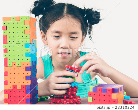 Asian child is playing puzzle plastic block Asian child is playing puzzle plastic block 28310224