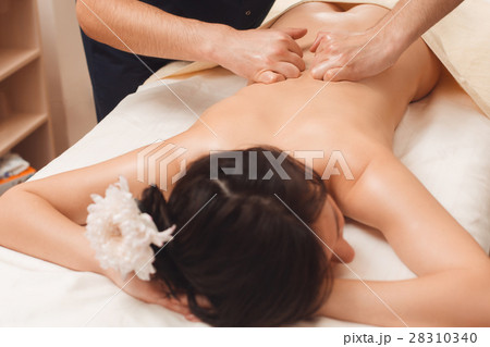 Relaxed woman enjoying massage at spa Relaxed woman enjoying massage at spa 28310340
