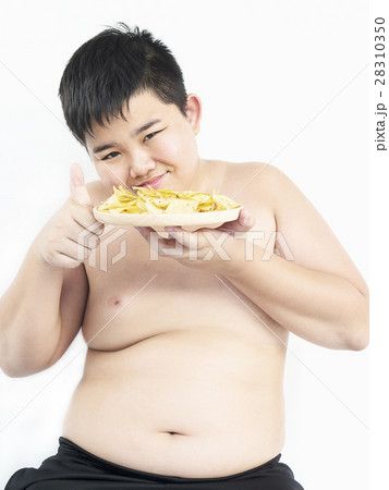 Fat boy is happily eating chip. 28310350