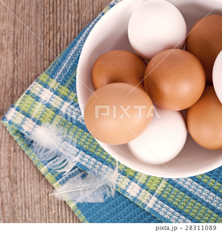 eggs in a bowl, towel and feathers eggs in a bowl, towel and feathers 28311089