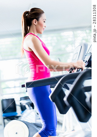 Sportive girl doing workout on treadmill 28311308