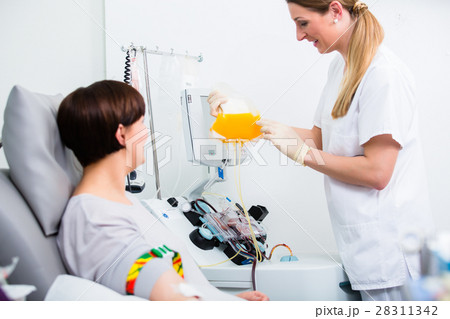 Nurse showing patient donating own blood  28311342
