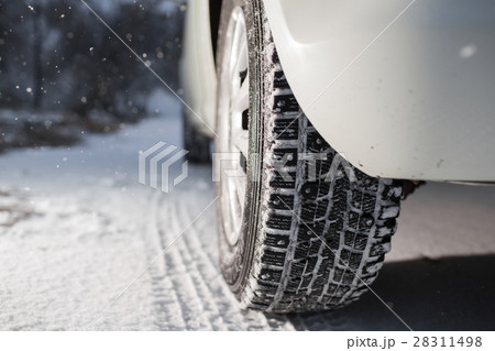 Closeup of car tires in winter. the first snow in 28311498