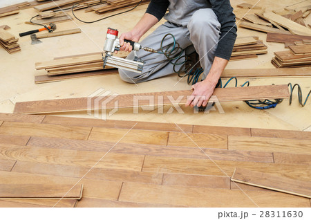 Installing a wooden floor. Installing a wooden floor. 28311630