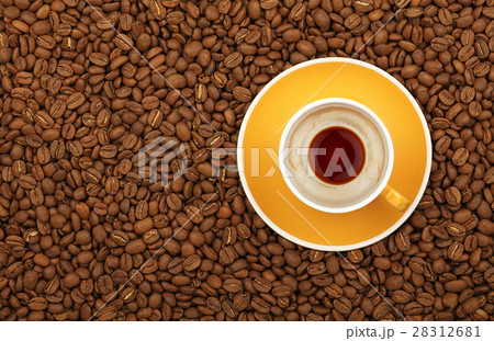 Empty black coffee yellow cup and saucer on beans 28312681