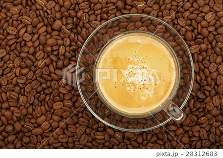 Full latte glass transparent cup on coffee beans 28312683