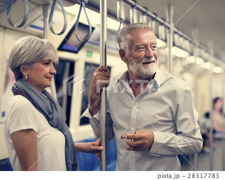 Senior couple traveling inside train subway Senior couple traveling inside train subway 28317783