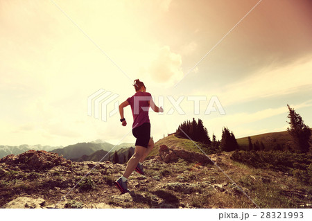 young woman trail runner running on mountain peak young woman trail runner running on mountain peak 28321993