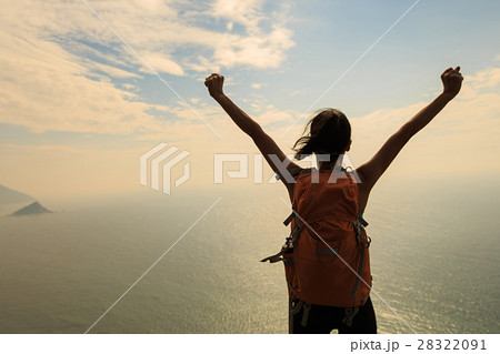 cheering young woman hike at seaside mountain peak cheering young woman hike at seaside mountain peak 28322091