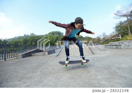young skateboarder riding skateboard at skatepark 28322148