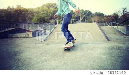 young skateboarder riding skateboard at skatepark 28322149