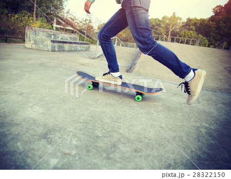 skateboarder legs riding skateboard at skatepark 28322150