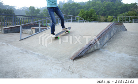 skateboarder legs riding skateboard at skatepark 28322232