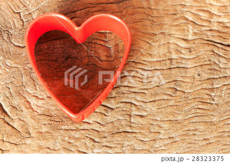red plastic heart shaped on old wood 28323375