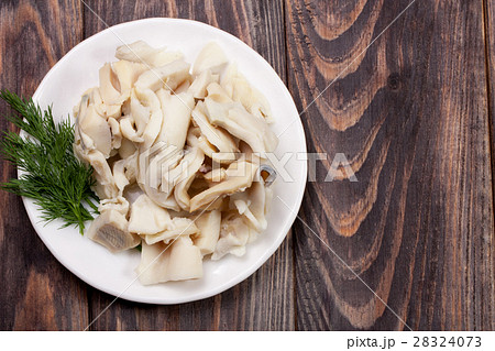 sliced squid on a plate on a dark wooden 28324073