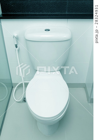 White toilet bowl in a bathroom 28324931
