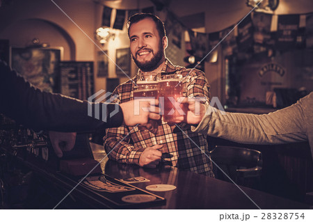 Cheerful old friends drinking draft beer at bar 28328754