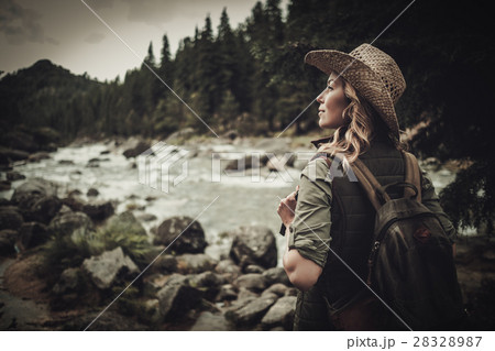 Beautiful woman hiker near wild mountain river. 28328987