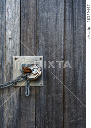 Rusty lock on the old wooden door 28329447